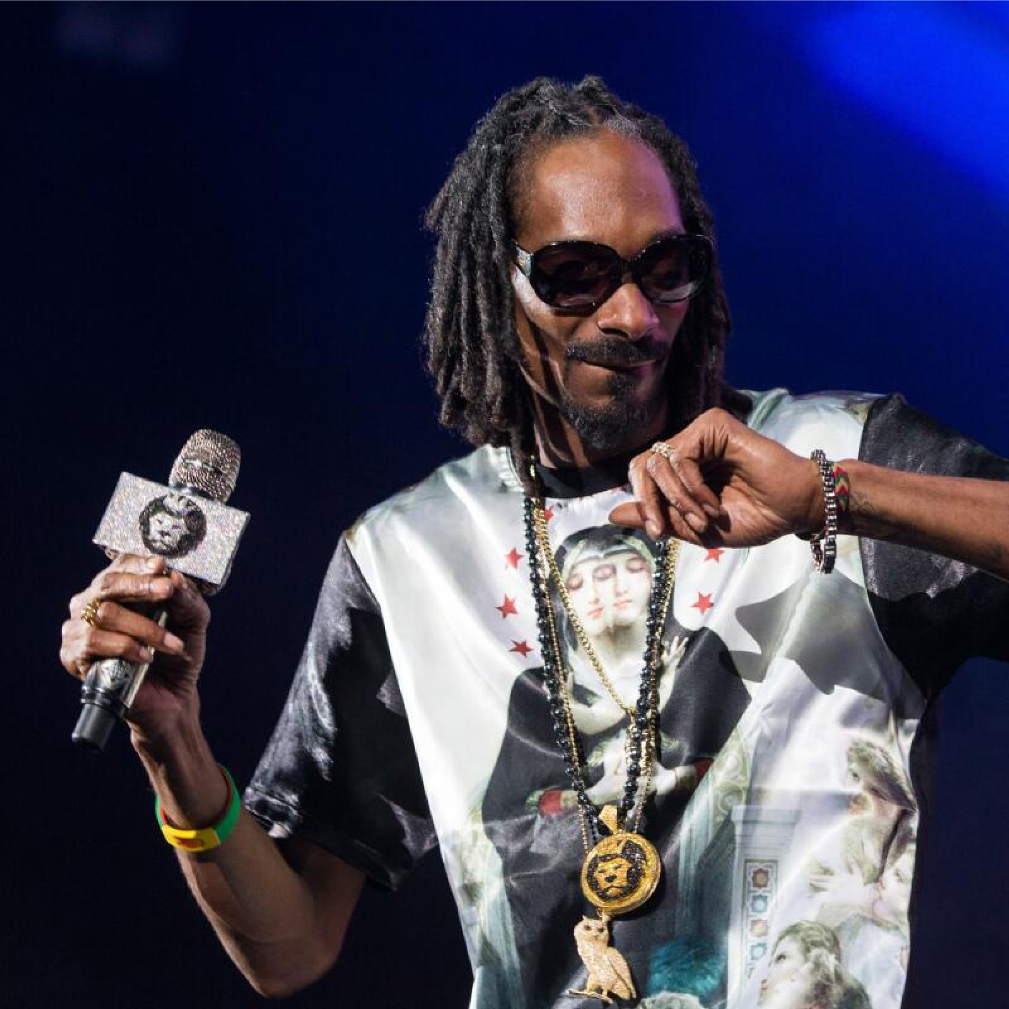 Rapper performing on stage wearing a King Ice lion-head pendant