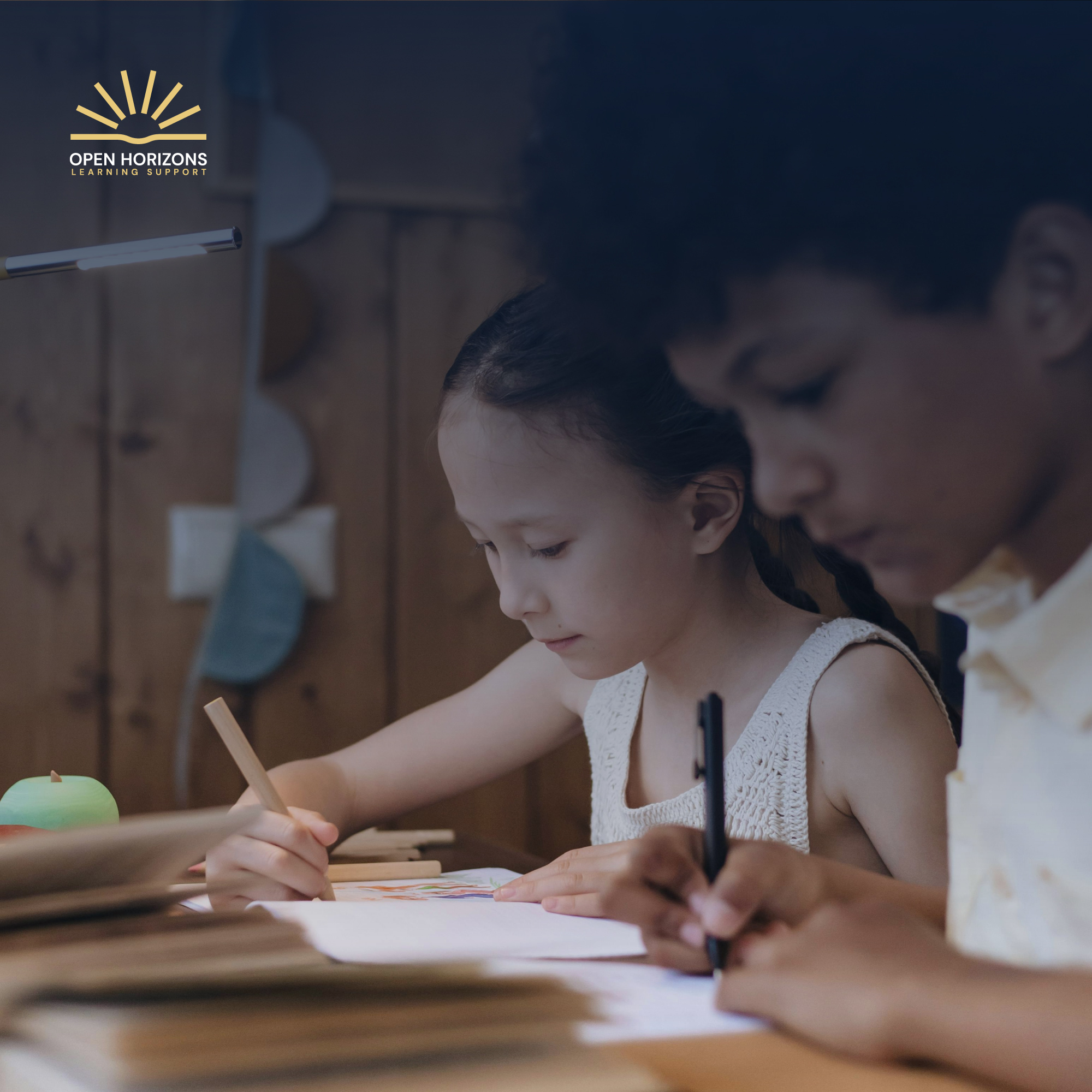 Two children studying together, with the Open Horizons logo in the corner